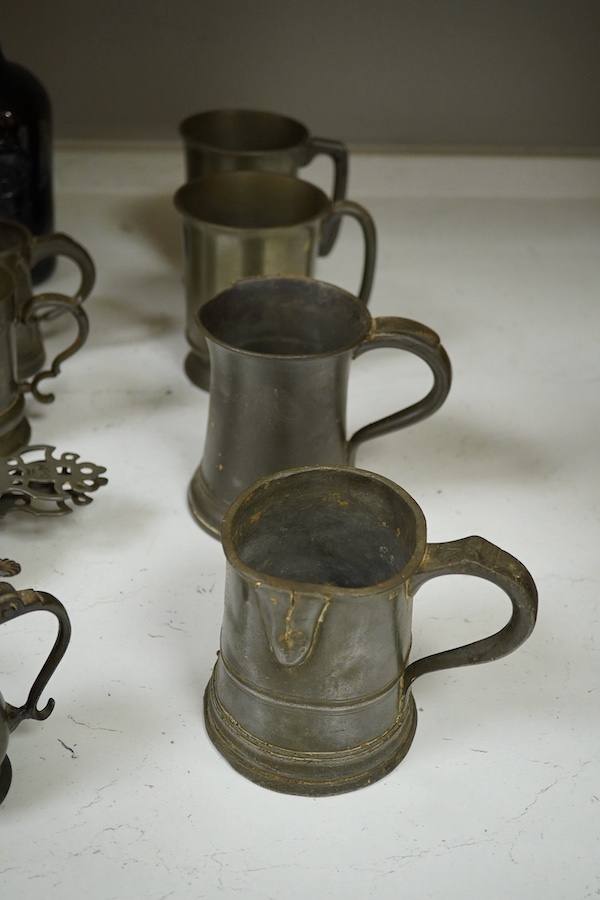 A collection of 18th and 19th century pewter mugs and other items including a 19th century wine bottle, bottle 27cm high. Condition - fair